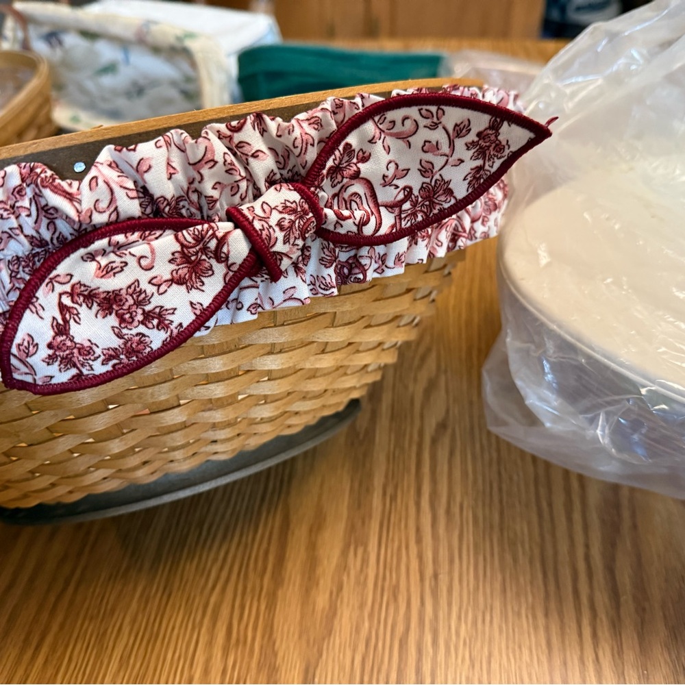 Medium oval Longaberger basket in warm brown stain with protector, lid, fabric